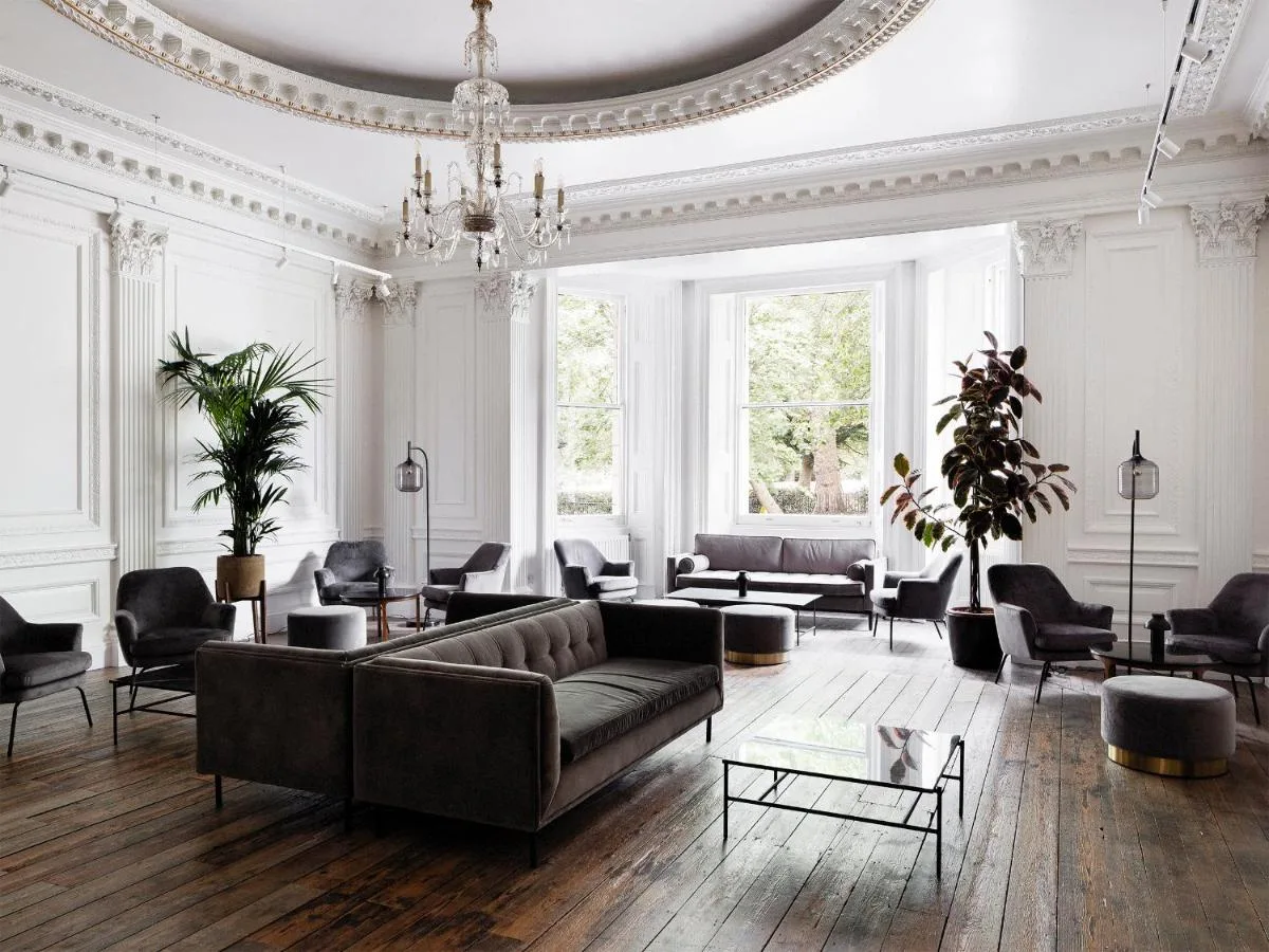 A large living room with a couch and chairs inside The Columbia, Lancaster Gate